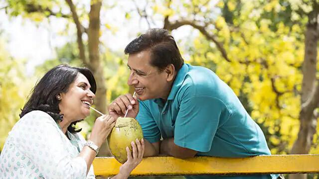 couple drinking from coconut